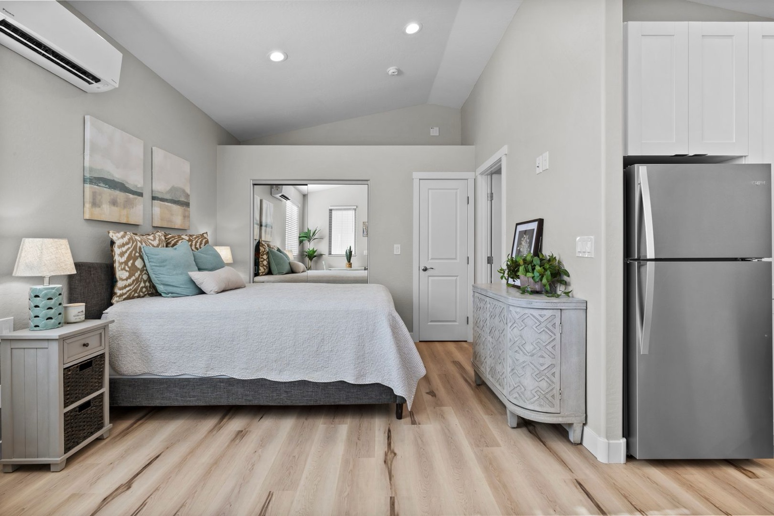 Bedroom and refrigerator inside a Baja Bungalows tiny home